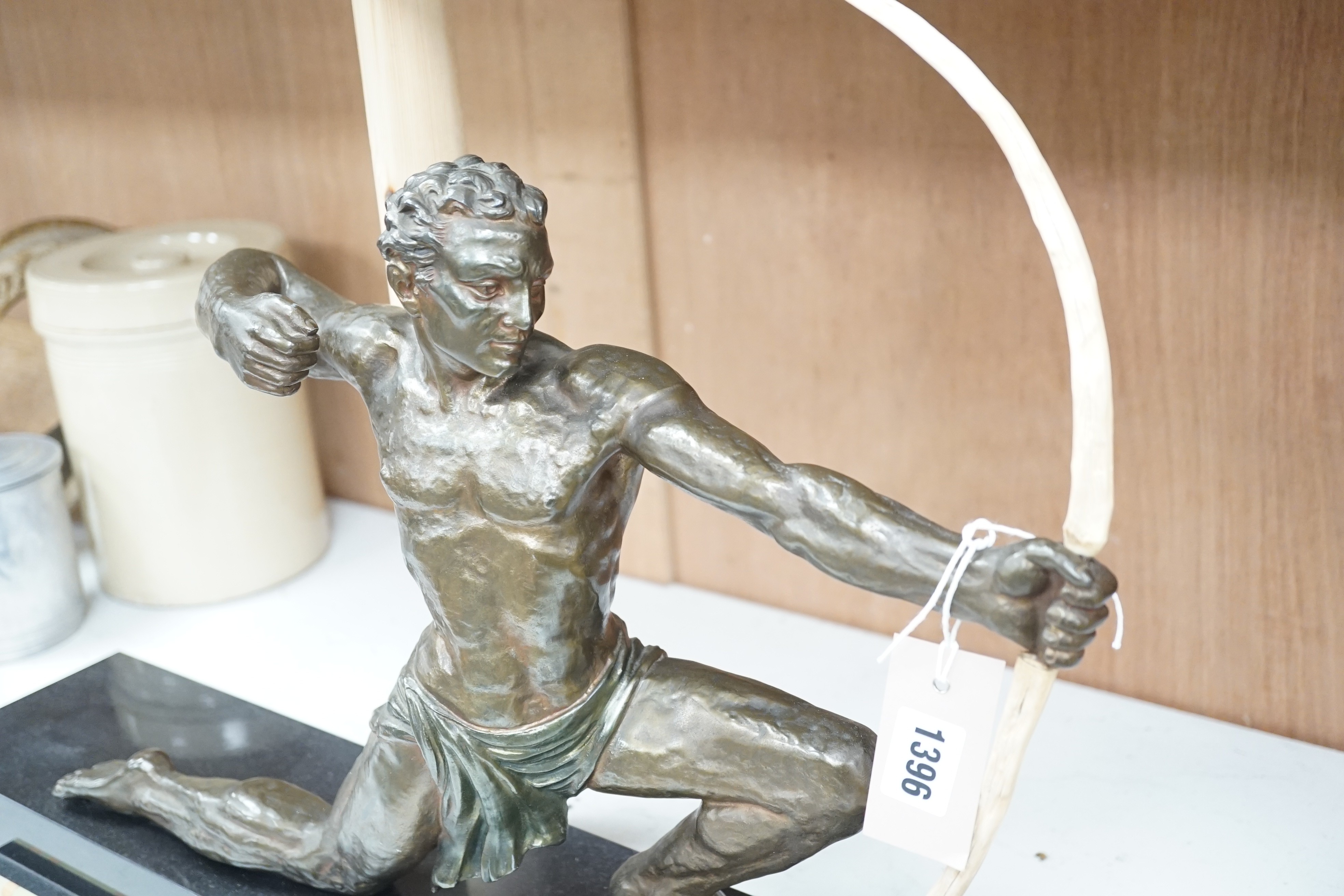 A 1930's patinated spelter figure of an archer, on a marble base, 60cms wide